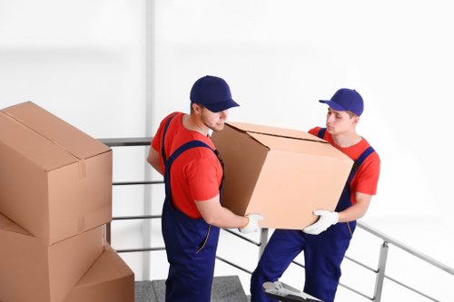 Man with van removal team loading furniture in Harrow on the Hill