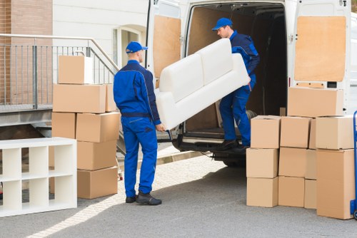 Office relocation with desks and equipment being loaded for transport