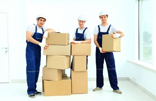 Professional mover carrying boxes on a narrow Harrow on the Hill staircase