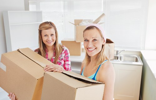 Local house movers unloading belongings at a nearby home